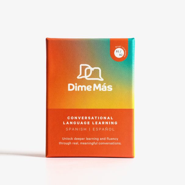 A colourful box for Dime Más conversational language learning cards.